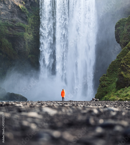 Tourist on the Skogafoss waterfall background. Travelling on Iceland. Tourist in the famouns place in Iceland. Travel - image photo