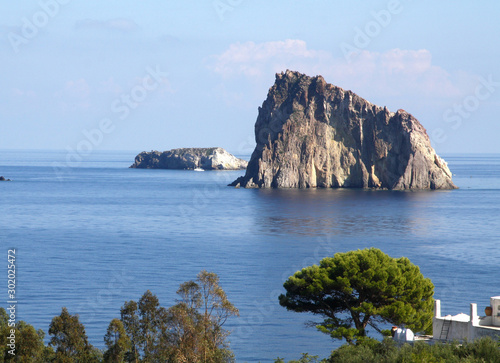 Lisca Bianca Rock with Trees in the Foreground Viewed From panarea Island, Aeolian Islands  photo