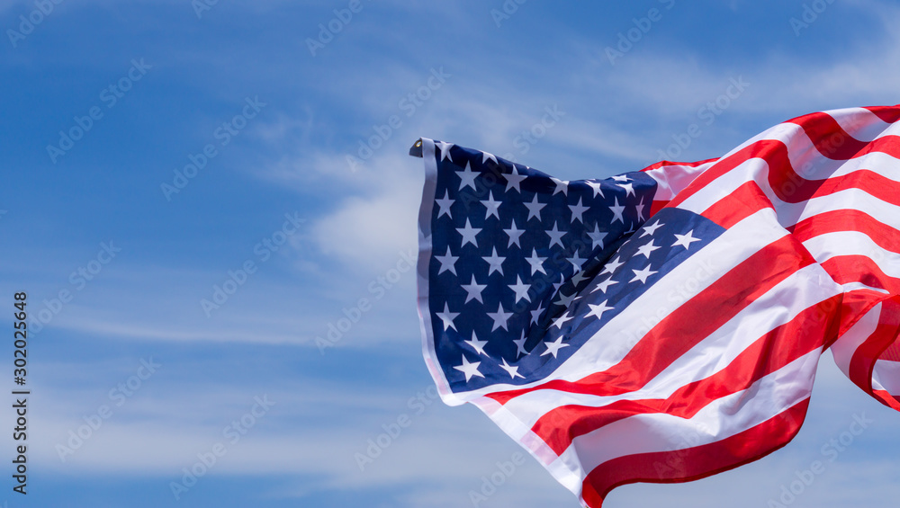 US American flag on blue sky background. For USA Memorial day, Veterans day, Labor day, or 4th of July celebration. Top view, copy space for text. - obrazy, fototapety, plakaty 