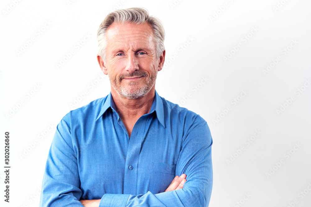 Studio Shot Of Mature Man Against White Background Smiling At Camera Studio Shot Of Mature Man Against White Background Smiling At Camera