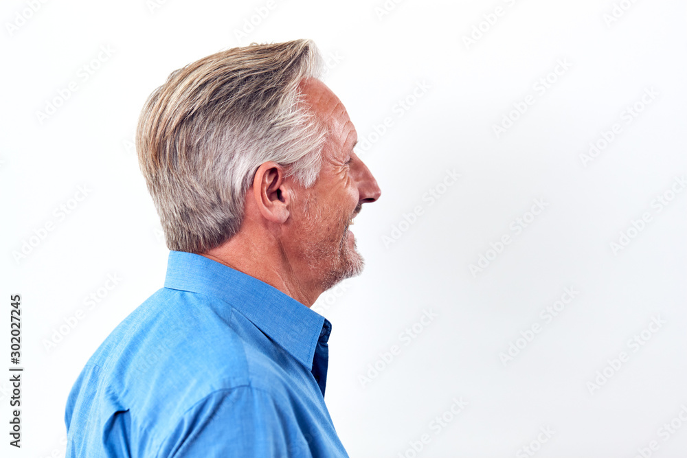 Studio Shot Of Mature Man Against White Background Laughing At Camera Studio Shot Of Mature Man Against White Background Laughing At Camera