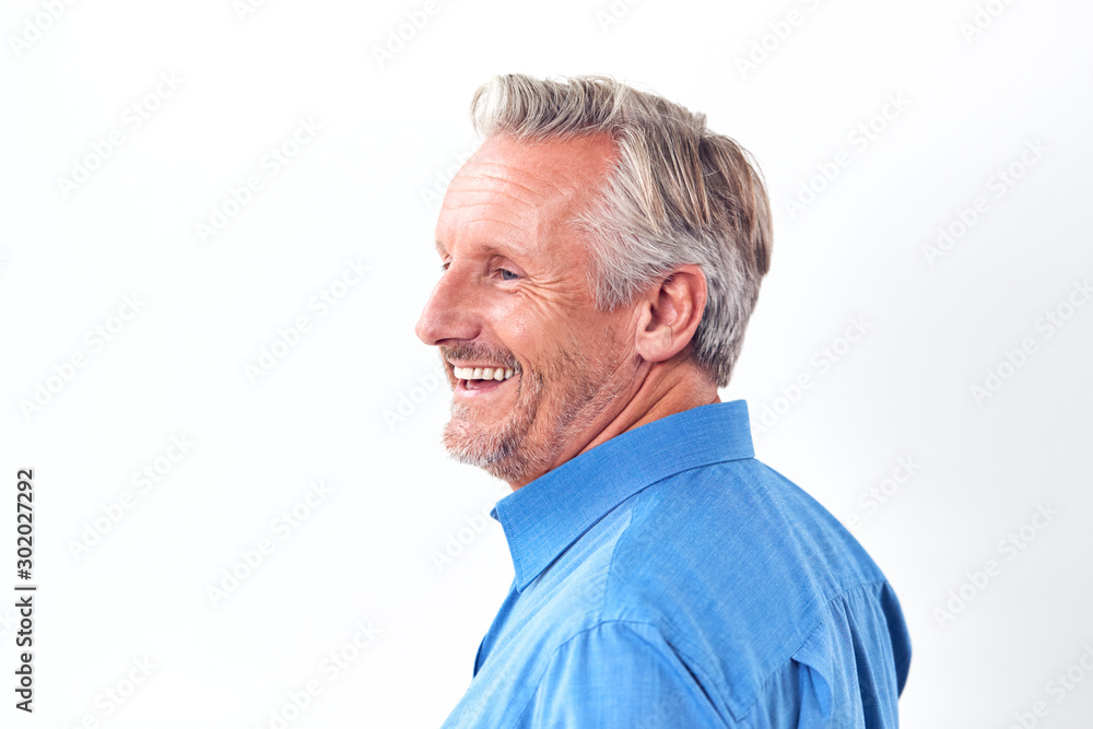 Studio Shot Of Mature Man Against White Background Laughing At Camera Studio Shot Of Mature Man Against White Background Laughing At Camera