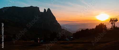 Beautiful alpine sunset view with the fantastic Schlern summit silhouette at the famous Seiser Alm, South Tyrol, Italy