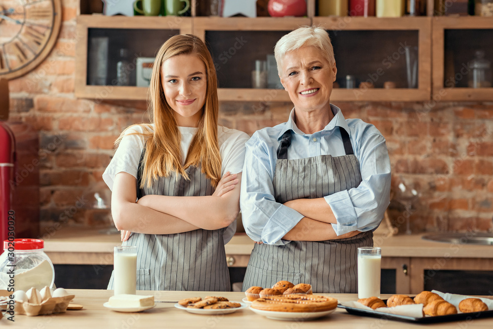 Adult mother and daughter baking together at home Adult mother and daughter baking together at home
