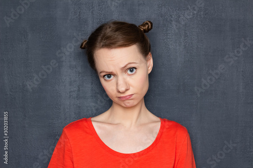 Portrait of upset disappointed girl with apologetic expression © Andrei Korzhyts