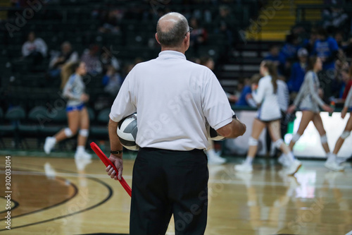 A line judge holds the ball and flag during timeout