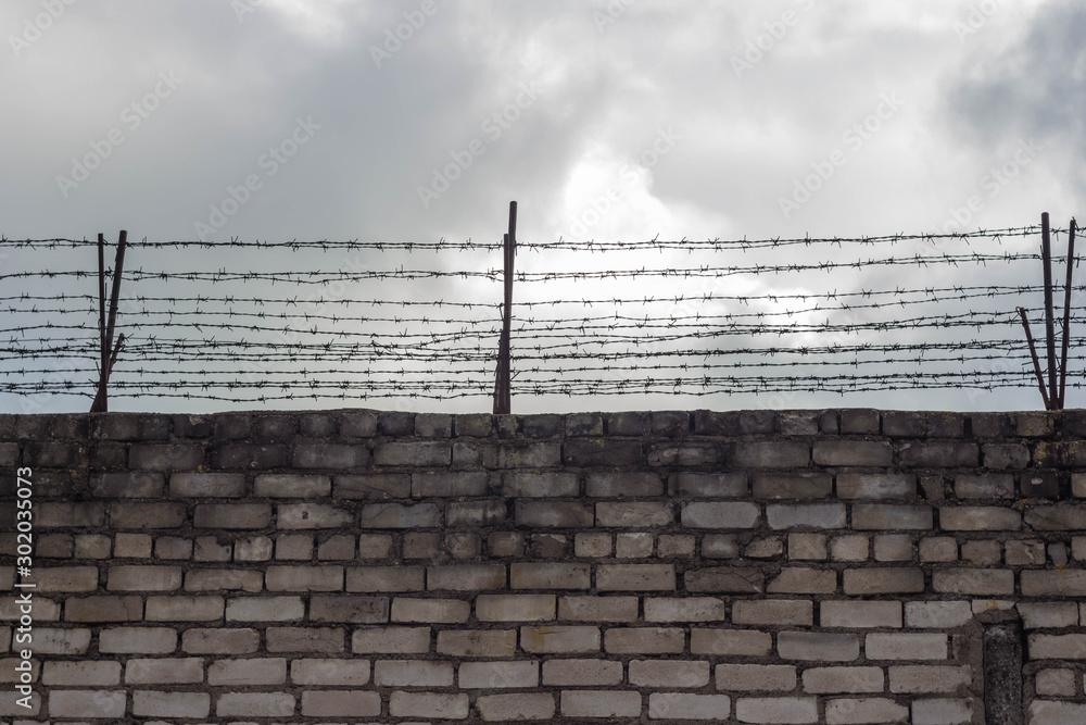 Barbed wire on the background of the blue sky. Symbol of the daydream on the liberty. Barbed wire on the background of the blue sky. Symbol of the daydream on the liberty.