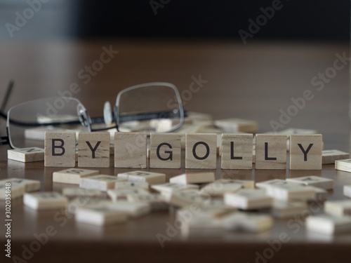 The concept of by golly represented by wooden letter tiles photo