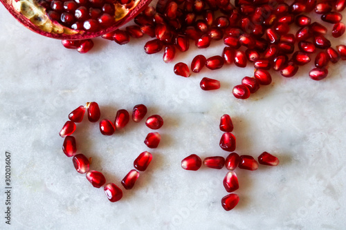 Heart made of red pomegranate seeds 
