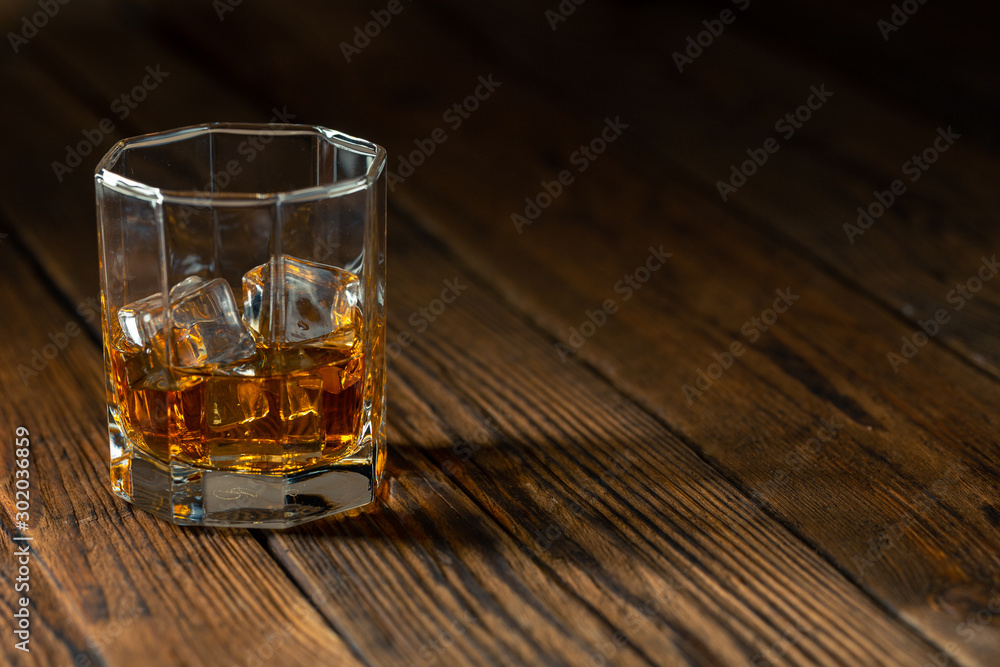 Whiskey in glass with ice Whiskey in glass with ice