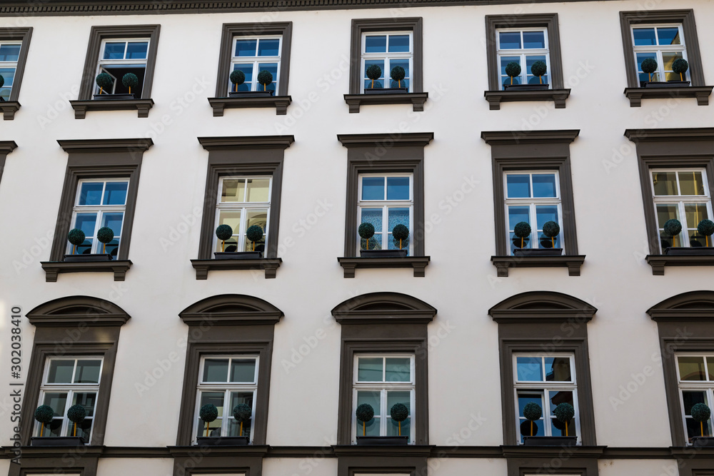 Obraz premium White wall with windows. Facade of ancient house