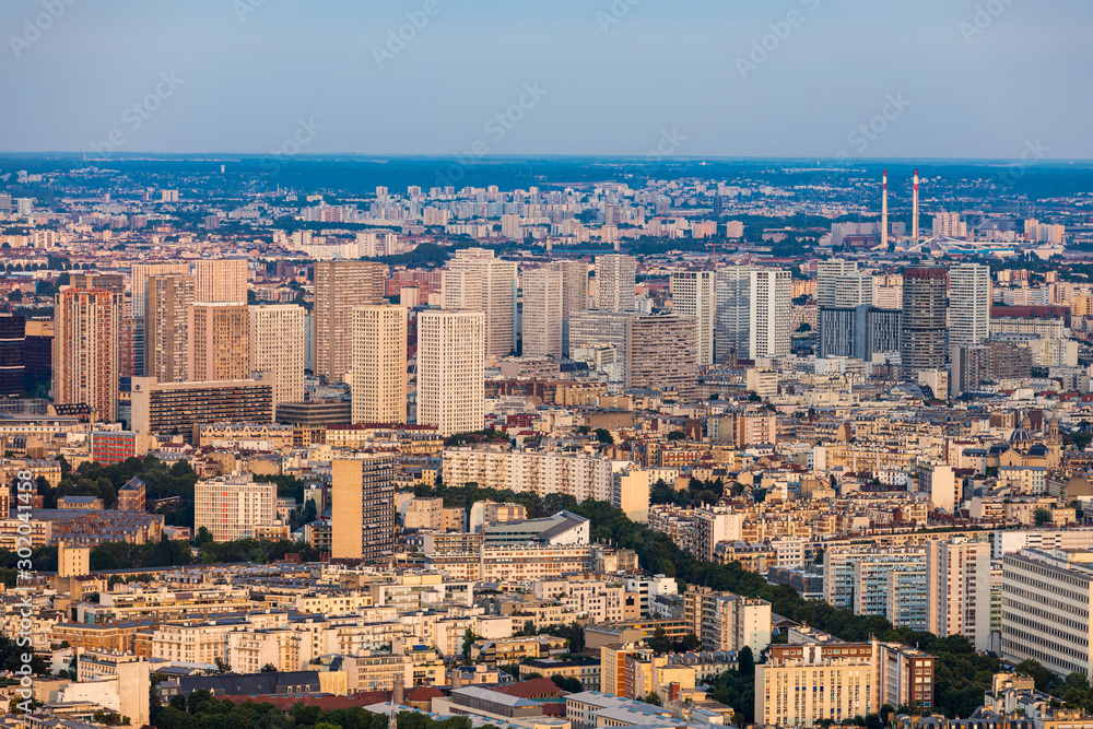 Classic Parisian buildings. Aerial view of roofs. Paris roofs panoramic overview at summer day, France. View of typical parisian roofs with mansards and chimneys in Paris, France. Classic Parisian buildings. Aerial view of roofs. Paris roofs panoramic overview at summer day, France. View of typical parisian roofs with mansards and chimneys in Paris, France.