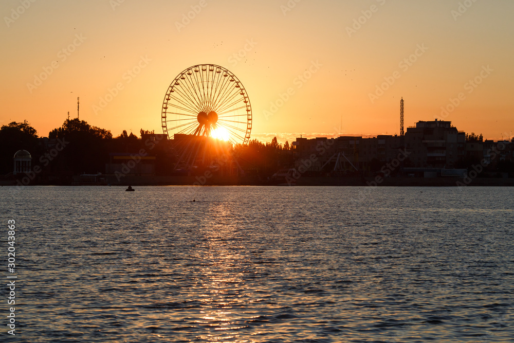 Ferris wheel on the background of sunrise, Berdyansk city