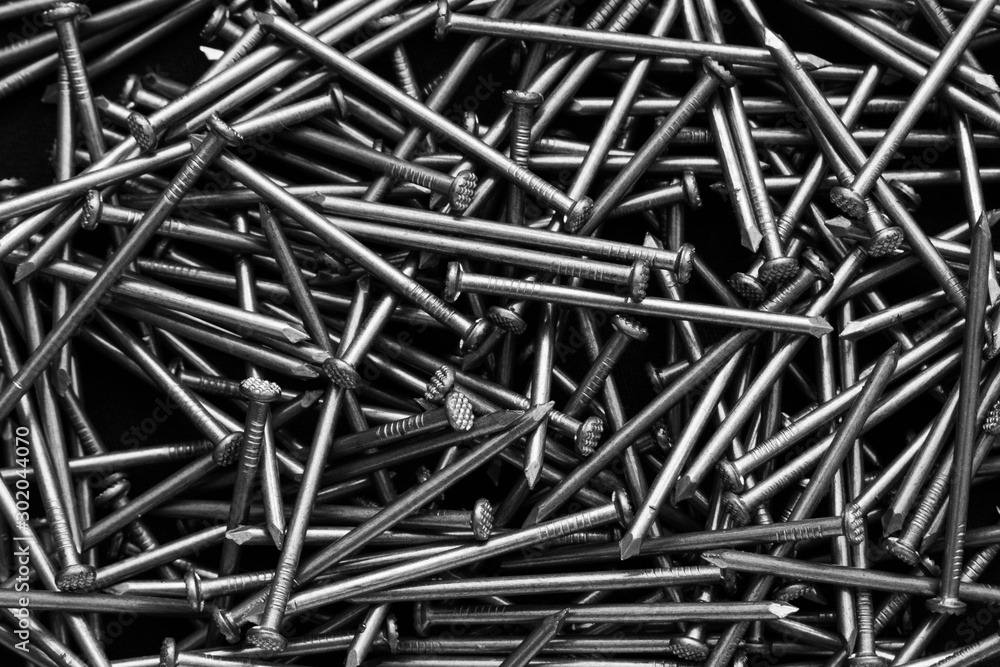 Close-up A scattering of nails. Construction Materials. Monochrome photo. Close-up A scattering of nails. Construction Materials. Monochrome photo.