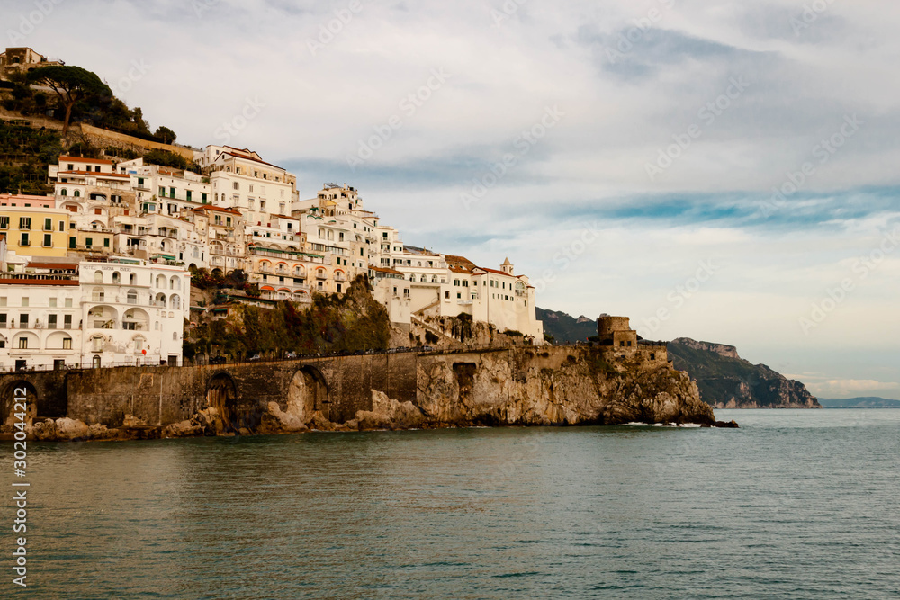 AMALFI, ITALY NOVEMBER 7 2019: Amalfi Panoramic evening city and nature view on houses, fortress and sea