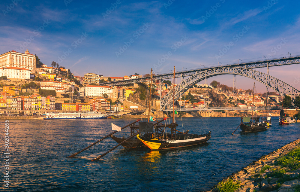 Oporto or Porto city skyline, Douro river, traditional boats and Dom Luis or Luiz iron bridge. Porto, Portugal, Europe.