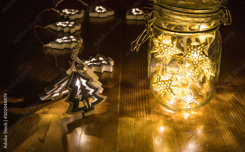 Christmas fairy lights in a mason jar, glowing in the dark, fairy lights in mason jar with selective focus, glitter overlay
