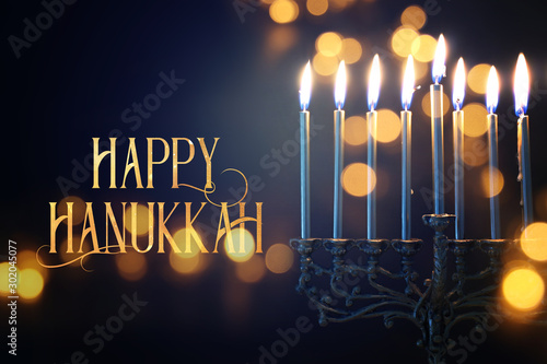 Religion image of jewish holiday Hanukkah background with menorah (traditional candelabra) and candles