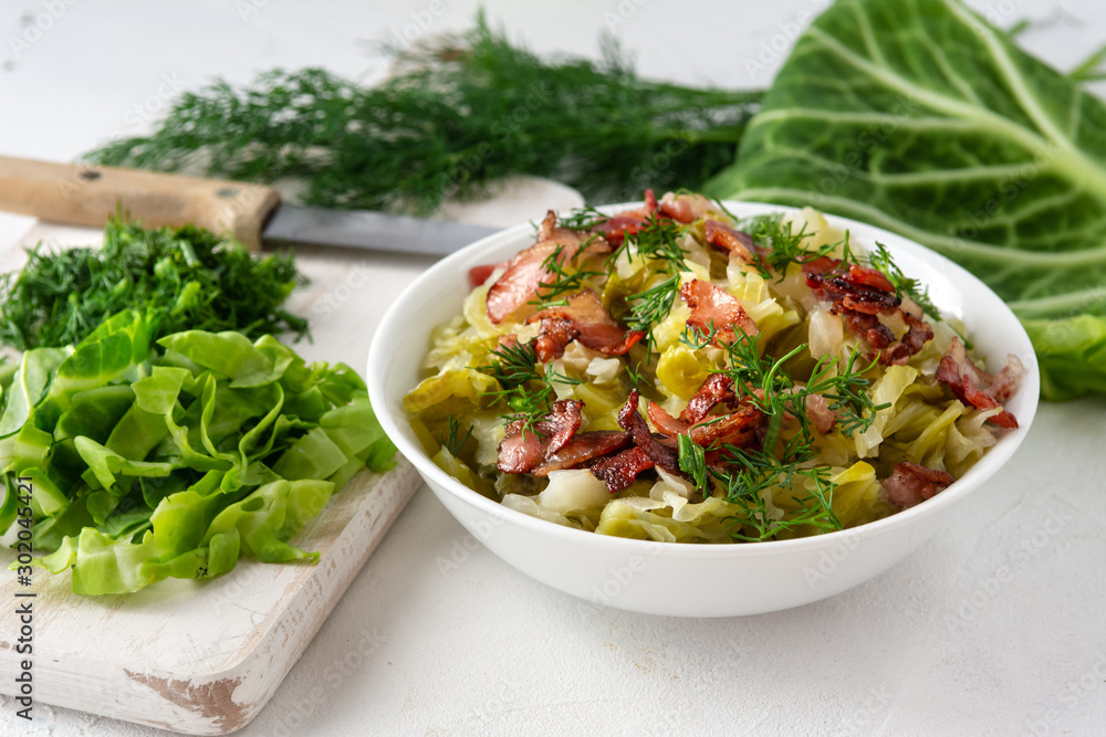 Stewed young cabbage with dill and grilled bacon. Stewed young cabbage with dill and grilled bacon.