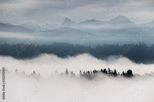 Foggy layered mountain landscape in Fort Langley, Fraser Valley, Lower Mainland, British Columbia, Canada