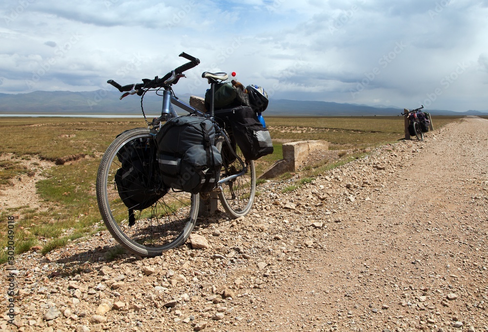 Unpaved road and two bicycles near Son-Kul lake Unpaved road and two bicycles near Son-Kul lake