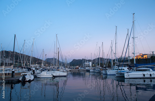 wooden surface pier and boats docked at dawn in the marina of Cartajena