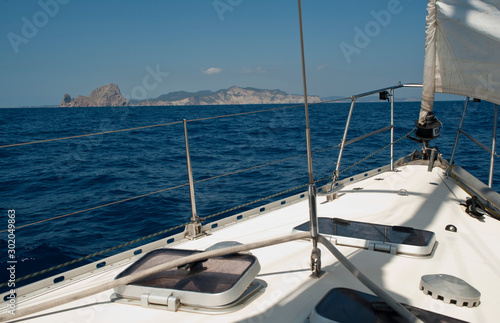 bow of sailboat with open genoba the city of ibiza in the background