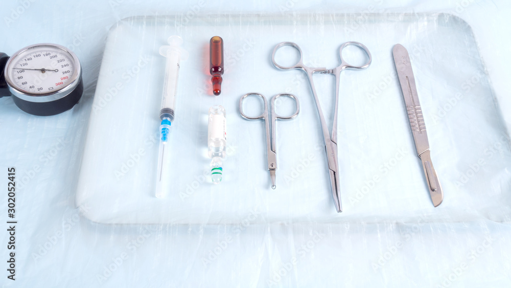 Surgical instruments on a metal tray in the operating room Surgical instruments on a metal tray in the operating room