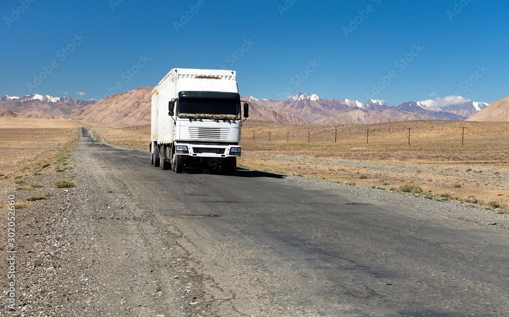 Pamir highway or pamirskij trakt and white truck