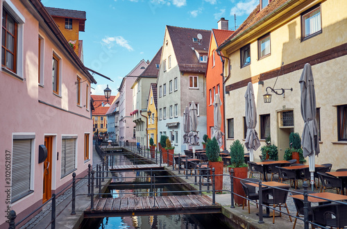Old street with a water canal and restaurant in Memmingen. photo