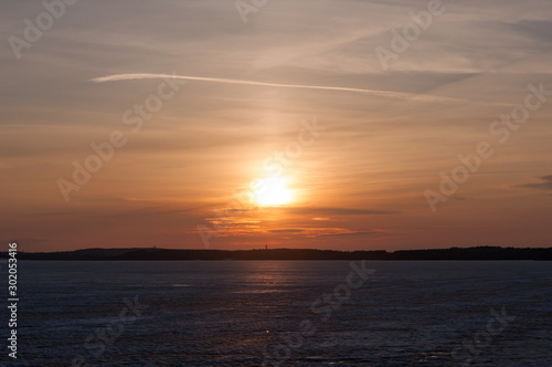 Low winter sun over iced lake © Jani Katajisto