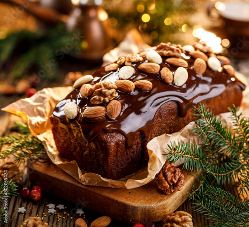 Papier peint Gingerbread cake, Christmas gingerbread cake covered with chocolate and decorated with nuts and almonds on the holiday table