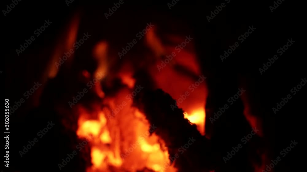A steady slow motion focus pull shot of Forest fires burning leaving hot coals and embers to continue to spread A steady slow motion focus pull shot of Forest fires burning leaving hot coals and embers to continue to spread