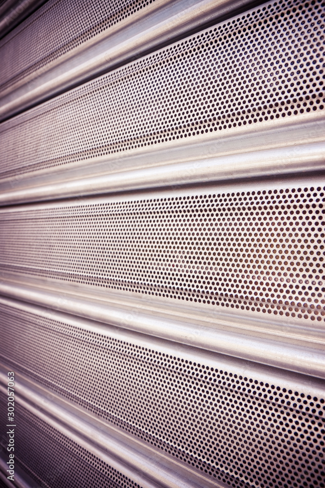 New closed metallic shutter door with perforated sheet Photos | Adobe Stock