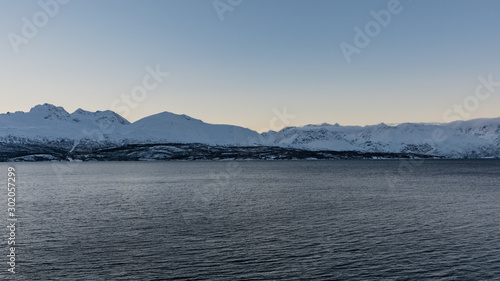Snowy mountains by a fjord in northern Norway in winter