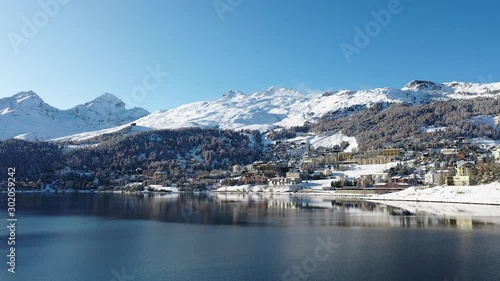 Lake of St. Moritz and beautiful Swiss village covered with snow