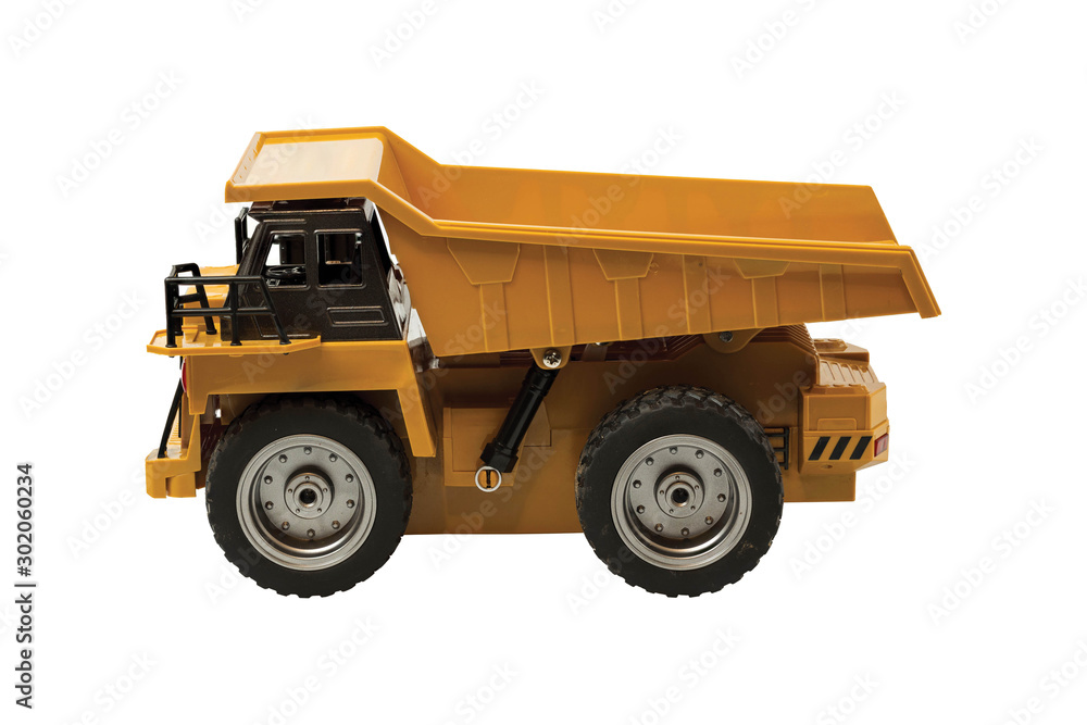 View of radio controlled model dump truck isolated on a white background. Free time. Children and adults concept. View of radio controlled model dump truck isolated on a white background. Free time. Children and adults concept.