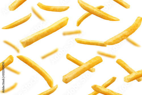 Fototapet Falling french fries, potato fry isolated on white background, selective focus