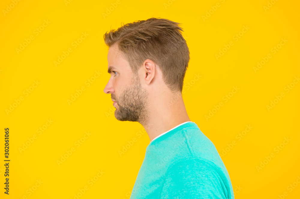 Fototapeta premium portrait of perfection. Male barber care. mens beauty. Hair and beard care. charismatic macho man profile look. guy sexy and stylish bristle. handsome man unshaven face. sexy guy yellow background