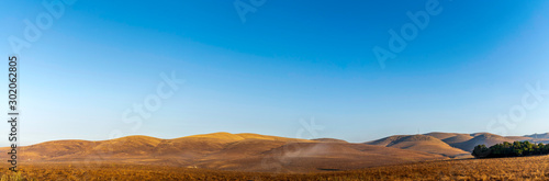 Panorama of brown, golden hills 