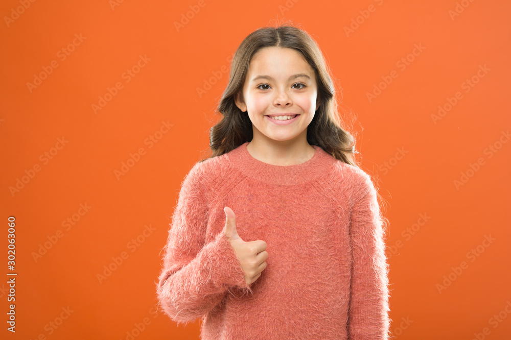 Success is not final. cheerful child orange background. carefree childhood. her healthy smile. happy childrens day. little girl smiling. small kid autumn sweater. feel comfortable in casual fashion Success is not final. cheerful child orange background. carefree childhood. her healthy smile. happy childrens day. little girl smiling. small kid autumn sweater. feel comfortable in casual fashion