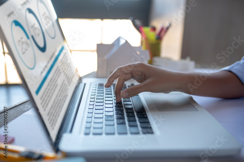 Close up of businesswoman typing e-mail for investor