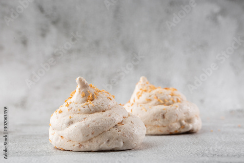 Obraz na płótnie French meringue cookies, macro shot on bright marble background. Tray of meringues. Closeup meringue photo. Dessert background. Sweets. Food. Flat lay and copy space. Top view. Horizontal w salonie