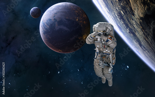 Astronaut, planets in deep space, beautiful space landscape. Science fiction. Elements of this image furnished by NASA