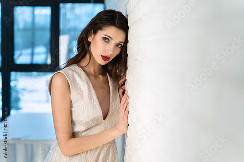 Beautiful girl bride in front of the camera, designer dress, sensual look.