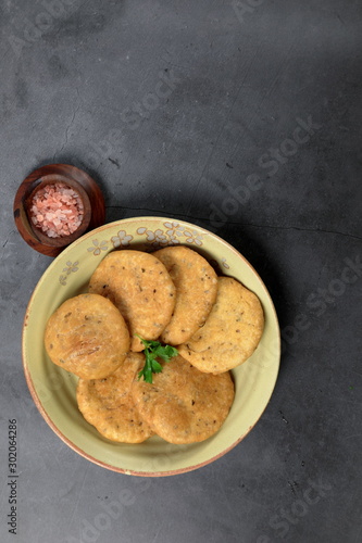 Overhead view of Mathri, an Indian snack made of  whole wheat flour or all purpose flour with fenugreek leaves and Carom seeds.