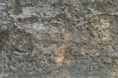 Texture of natural gray weathered stone. Background of stone covering a wall or floor texture surface with lines. Old stone with.