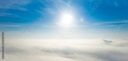 Canvas Print Aerial photo above the fog or white clouds with shining sun