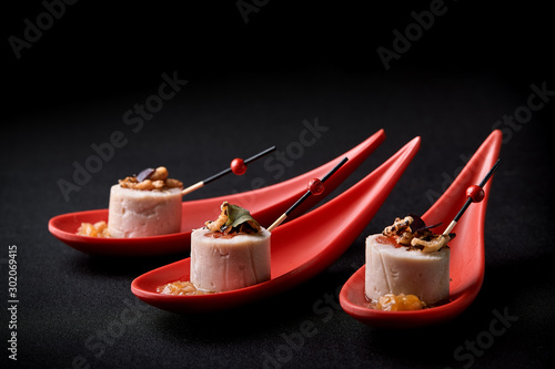 Valokuvatapetti Goose liver pate, foie gras, served on black stone in Japanese red spoons