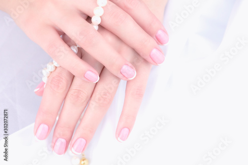 Wedding manicure. Female hand with french manicure on a white background.
